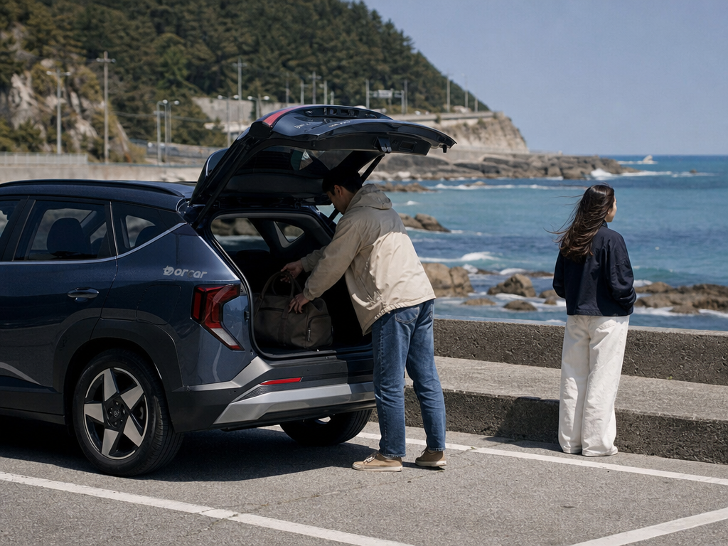 Travelers loading a compact rental SUV beside the Gangneung coast for a two-day road trip